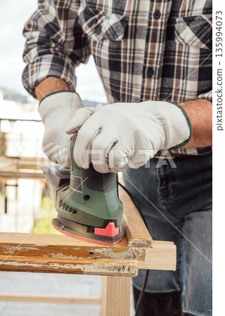 Carpenter at work, restoring an old wooden window. Carpentry. 135994073