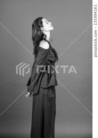 Woman posing in studio, showing fashion style and confidence Woman posing in studio, showing fashion style and confidence 135994161