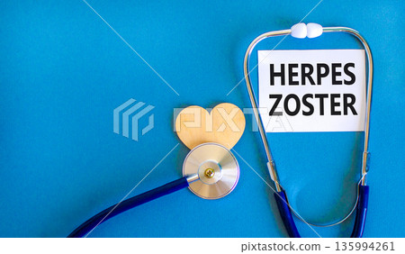 Herpes zoster symbol. Concept words Herpes zoster on beautiful white card. Wooden heart and stethoscope. Beautiful blue background. Medical healthy lifestyle herpes zoster concept. Herpes zoster symbol. Concept words Herpes zoster on beautiful white card. Wooden heart and stethoscope. Beautiful blue background. Medical healthy lifestyle herpes zoster concept. 135994261