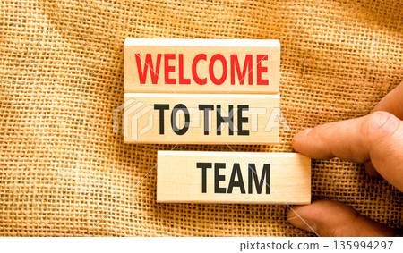 Support, help welcome to the team symbol. Concept words Welcome to the team on beautiful wooden blocks. Beautiful canvas background. Businessman's hand. Business welcome to team concept. Copy space. 135994297