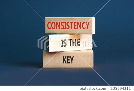 Consistency is the key symbol. Concept words Consistency is the key on beautiful wooden blocks. Beautiful grey background. Business consistency is the key concept. Copy space. Consistency is the key symbol. Concept words Consistency is the key on beautiful wooden blocks. Beautiful grey background. Business consistency is the key concept. Copy space. 135994311
