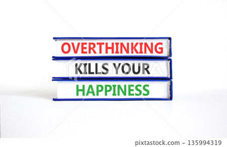 Overthinking kills your happiness symbol. Concept words Overthinking kills your happiness on books. Beautiful white paper background. Business overthinking kills happiness concept. Copy space. Overthinking kills your happiness symbol. Concept words Overthinking kills your happiness on books. Beautiful white paper background. Business overthinking kills happiness concept. Copy space. 135994319