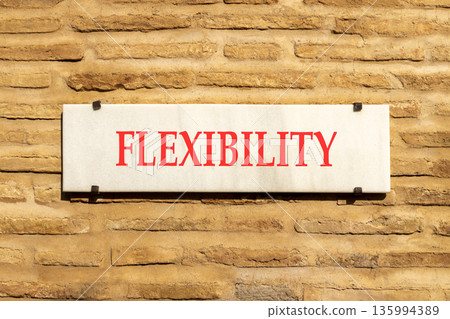 Flexibility symbol. Concept word Flexibility on beautiful white marble sign plate. Beautiful ancient brick wall background. Business flexibility concept. Copy space. Flexibility symbol. Concept word Flexibility on beautiful white marble sign plate. Beautiful ancient brick wall background. Business flexibility concept. Copy space. 135994389
