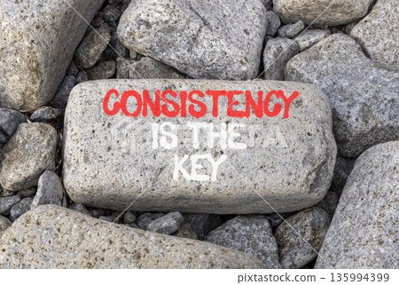 Consistency is the key symbol. Concept words Consistency is the key on beautiful grey stone. Beautiful grey stones background. Business consistency is the key concept. Copy space. 135994399