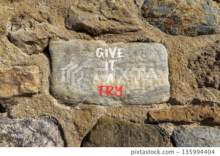 Give it a try symbol. Concept word Give it a try on beautiful stone. Beautiful stone wall background. Business give it a try concept. Copy space. Give it a try symbol. Concept word Give it a try on beautiful stone. Beautiful stone wall background. Business give it a try concept. Copy space. 135994404