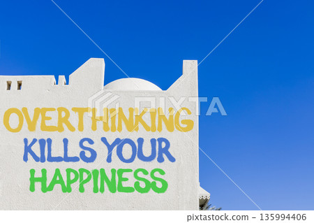 Overthinking kills your happiness symbol. Concept words Overthinking kills your happiness on white wall. Beautiful blue sky background. Business overthinking kills happiness concept. Copy space. Overthinking kills your happiness symbol. Concept words Overthinking kills your happiness on white wall. Beautiful blue sky background. Business overthinking kills happiness concept. Copy space. 135994406