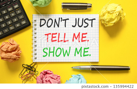Tell or show symbol. Concept words Do not just tell me, show me on beautiful white note. Beautiful yellow background. Black pen. Business tell or show concept. Copy space. Tell or show symbol. Concept words Do not just tell me, show me on beautiful white note. Beautiful yellow background. Black pen. Business tell or show concept. Copy space. 135994422