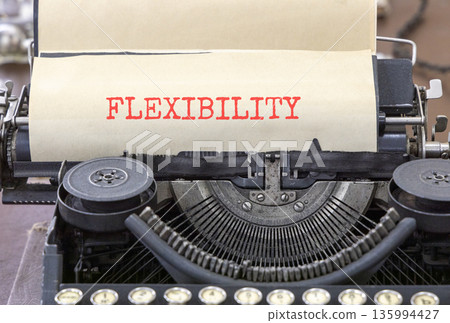 Flexibility symbol. Concept word Flexibility typed on beautiful old retro typewriter. Beautiful white paper background. Business flexibility concept. Copy space. 135994427