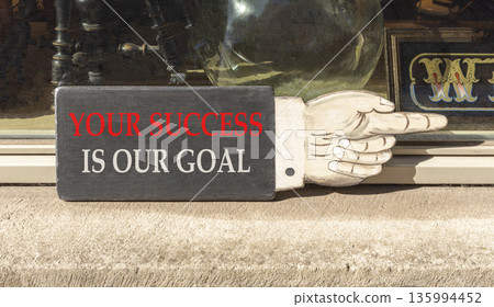 Your success is our goal symbol. Concept words Your success is our goal on beautiful wooden black sign. Beautiful store front background. Business your success is our goal concept. Copy space. Your success is our goal symbol. Concept words Your success is our goal on beautiful wooden black sign. Beautiful store front background. Business your success is our goal concept. Copy space. 135994452