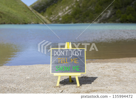 Tell or show symbol. Concept words Do not just tell me, show me on beautiful blackboard. Beautiful mountain lake background. Business tell or show concept. Copy space. Tell or show symbol. Concept words Do not just tell me, show me on beautiful blackboard. Beautiful mountain lake background. Business tell or show concept. Copy space. 135994472