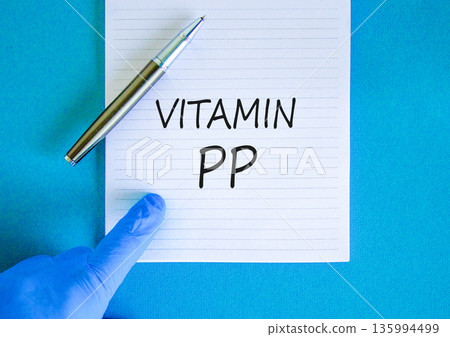 Vitamin PP symbol. Concept words Vitamin PP on beautiful white note. Doctor's hand in blue medical glove. Black pen. Beautiful blue background. Medical healthy lifestyle Vitamin PP concept. 135994499