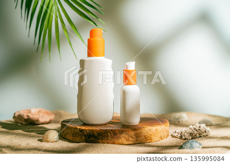 Two sun care bottles on wood stand 135995084