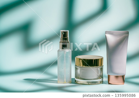 Three skincare products on blue 135995086