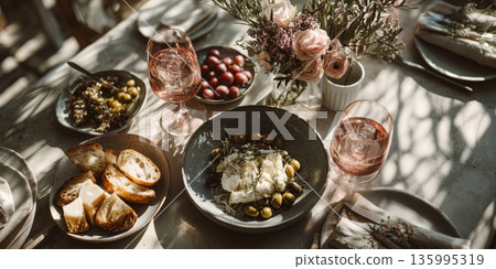A vibrant lunch scene features a table adorned with various dishes and drinks 135995319