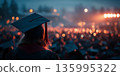 Graduation celebration viewed from behind with glowing lights in the distance 135995322