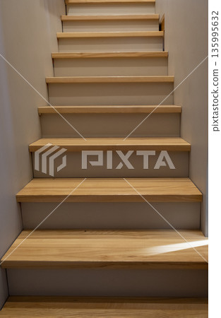 Empty staircase upstairs inside a modern house, light wood steps 135995632