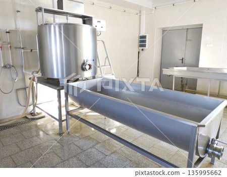 A cylindrical metal tank connected to a long rectangular bath. A cylindrical metal tank connected to a long rectangular bath. 135995662
