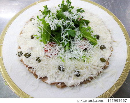 veal slices with mayonnaise, tuna and caper sauce on a white plate veal slices with mayonnaise, tuna and caper sauce on a white plate 135995667