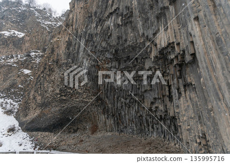 Towering vertical basalt columns form dramatic cliff wall at Symphony of Stones, layered volcanic rock creates strong geometric textures Towering vertical basalt columns form dramatic cliff wall at Symphony of Stones, layered volcanic rock creates strong geometric textures 135995716