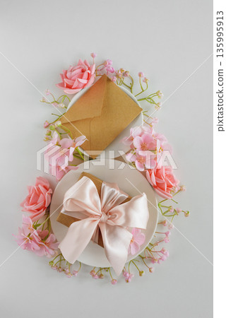 Coffee Cups, Gift Box, Envelope and Pink Flowers in Shape of Eight. Elegant Flatlay for International Womens Day Coffee Cups, Gift Box, Envelope and Pink Flowers in Shape of Eight. Elegant Flatlay for International Womens Day 135995913