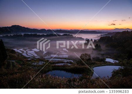 The rice terraces of Hoshitoge surrounded by a sea of clouds and a fantastic morning glow The rice terraces of Hoshitoge surrounded by a sea of clouds and a fantastic morning glow 135996283