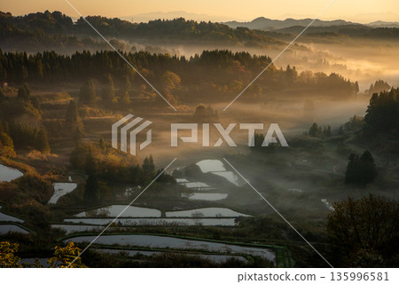 The rice terraces of Hoshitoge surrounded by a sea of clouds and a fantastic morning glow The rice terraces of Hoshitoge surrounded by a sea of clouds and a fantastic morning glow 135996581