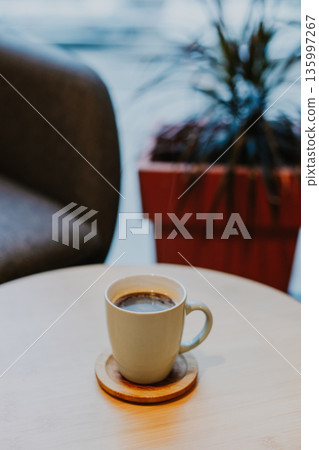 Cup of black coffee on a table in a cafe. 135997267