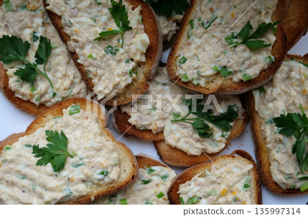 Toasted slices of wheat bread with egg salad and parsley leaves on top Toasted slices of wheat bread with egg salad and parsley leaves on top 135997314