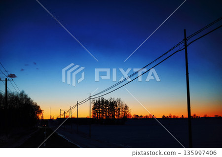 Scenery with the pre-dawn sky and electric poles Scenery with the pre-dawn sky and electric poles 135997406
