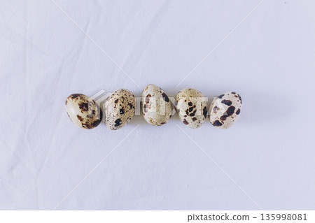 Quail eggs on a white background. Minimal concept. Flat lay. Quail eggs on a white background. Minimal concept. Flat lay. 135998081