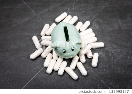 Health Affordability Concept With Savings Piggy Bank And Medical Capsules Health Affordability Concept With Savings Piggy Bank And Medical Capsules 135998137