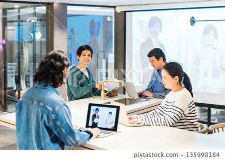 Businessmen and women having a meeting in the office Businessmen and women having a meeting in the office 135998184