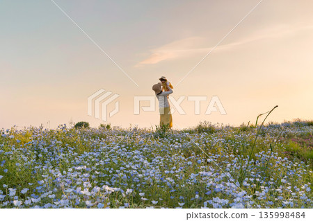 Parents and children playing in a nemophila field Parents and children playing in a nemophila field 135998484