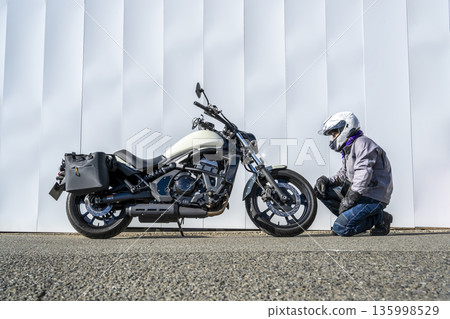 Large American motorcycle and male rider Large American motorcycle and male rider 135998529