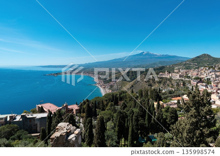 Taormina coast panorama with Mount Etna volcano in Sicily, Italy 135998574
