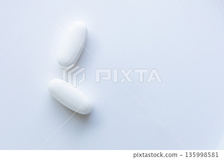 Pills and capsules on white minimal background 135998581