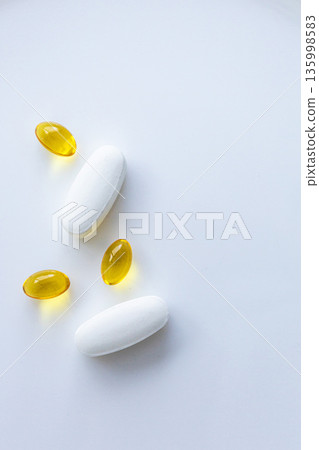 Pills and capsules on white minimal background 135998583