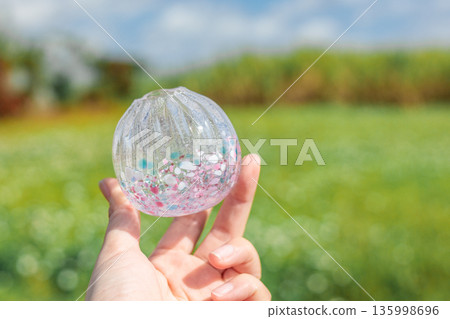 Glass work with sparkling spring-colored grains Glass work with sparkling spring-colored grains 135998696