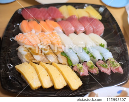 Assorted sushi served on a black plate 135998807