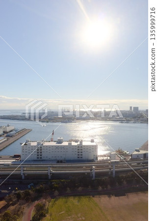 Aerial view of the Kobe Bay coastal city and harbor with reflections on the water Aerial view of the Kobe Bay coastal city and harbor with reflections on the water 135999716