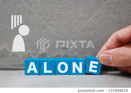 The word ALONE and an image of loneliness with a depressed silhouette. The word ALONE and an image of loneliness with a depressed silhouette. 135999878