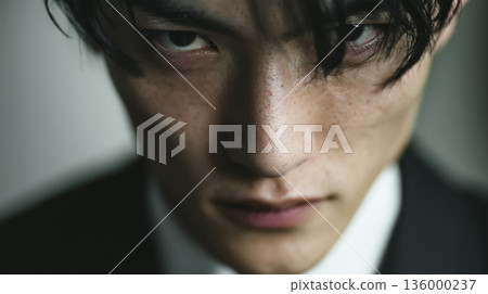 The tension and inner strength in his sharp gaze 136000237