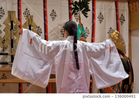 Kagura offering: Shrine maiden dancing the bell dance Kagura offering: Shrine maiden dancing the bell dance 136000491