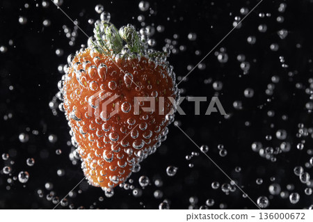 特寫鏡頭:草莓漂浮在水中,周圍環繞著氣泡。 特寫鏡頭:草莓漂浮在水中,周圍環繞著氣泡。 136000672
