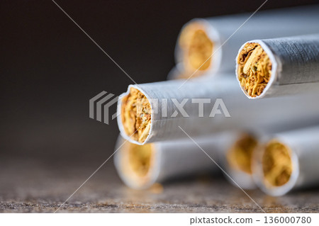 Extreme close-up of several cigarettes in a row showing tobacco texture and paper detail 136000780