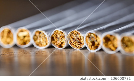 Extreme close-up of several cigarettes in a row showing tobacco texture and paper detail 136000781