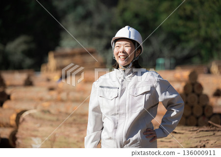 A middle-aged woman wearing work clothes Image of a female site supervisor A middle-aged woman wearing work clothes Image of a female site supervisor 136000911