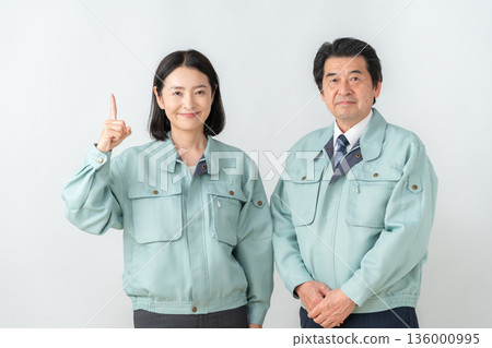 A middle-aged engineer in work clothes on a white background 136000995
