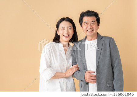 A middle-aged couple on a date with a beige background A middle-aged couple on a date with a beige background 136001040