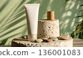 White Matte Cosmetic Tube on Limestone Pedestal with Wood Cap and Dappled Golden Hour Lighting 136001083
